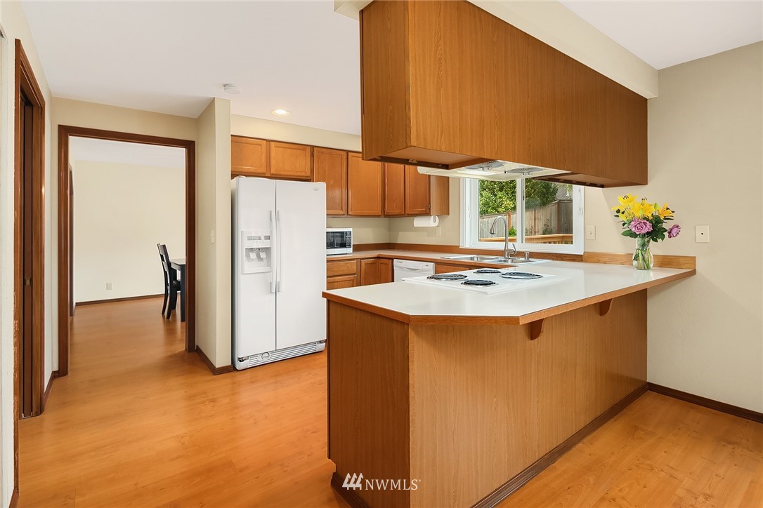 23423 9th Place West Bothell, WA 98021 - Photo 9 of 26 a kitchen with stainless steel appliances granite countertop a refrigerator a sink and a stove
