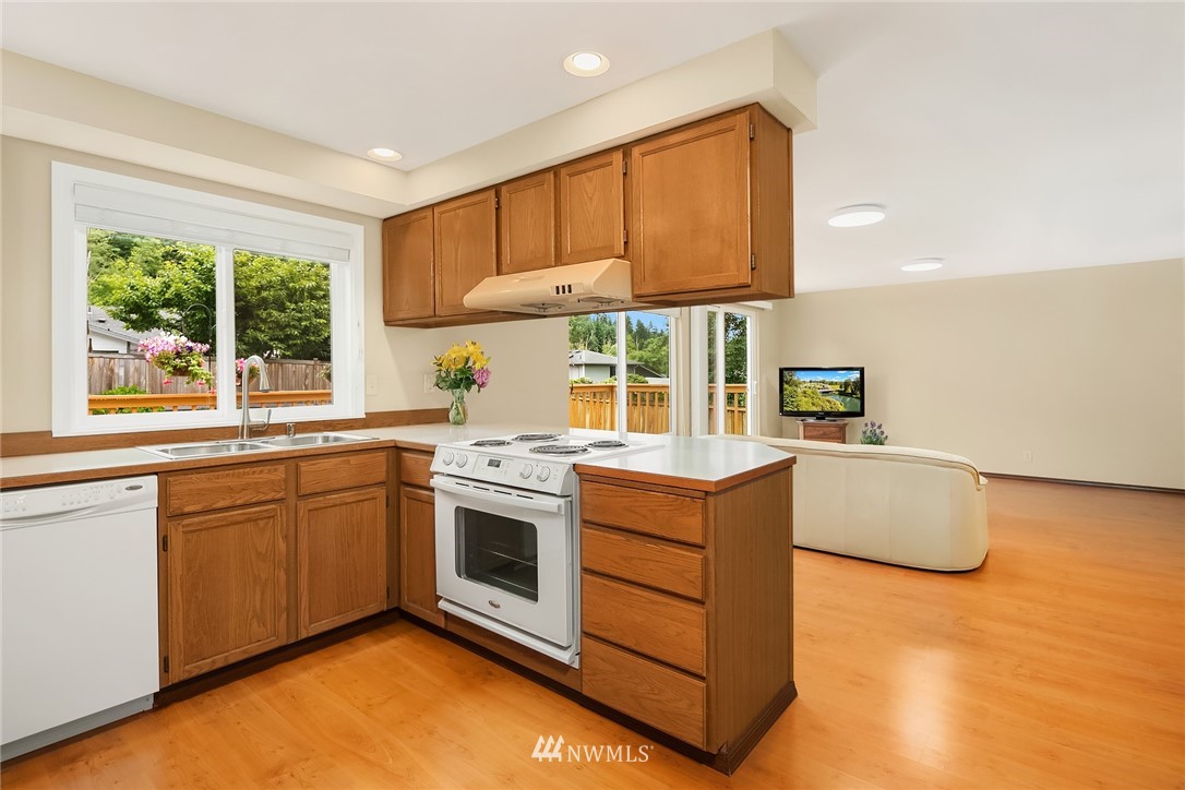 23423 9th Place West Bothell, WA 98021 - Photo 10 of 26 a kitchen with stainless steel appliances granite countertop a stove a sink and a microwave