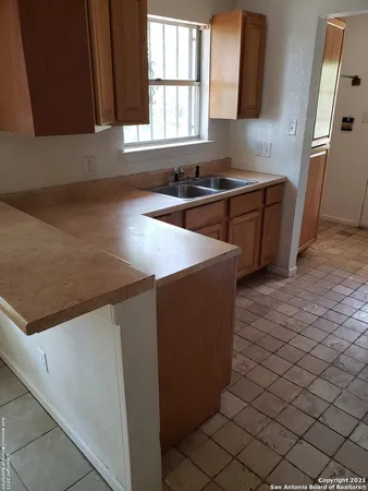a kitchen with stainless steel appliances a sink stove and cabinets