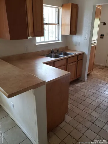 a kitchen with stainless steel appliances a sink stove and cabinets