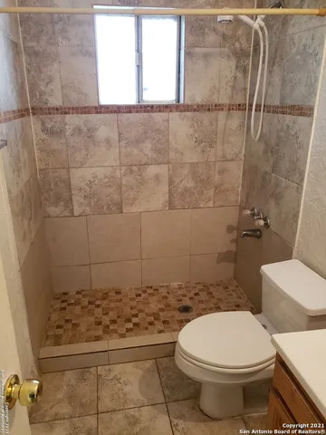 a bathroom with a toilet and a shower