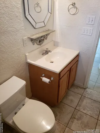 a bathroom with a sink mirror and toilet