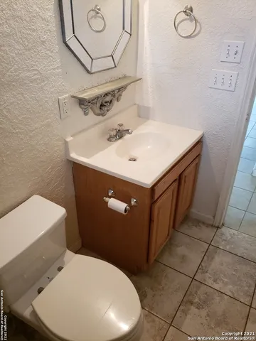 a bathroom with a sink mirror and toilet