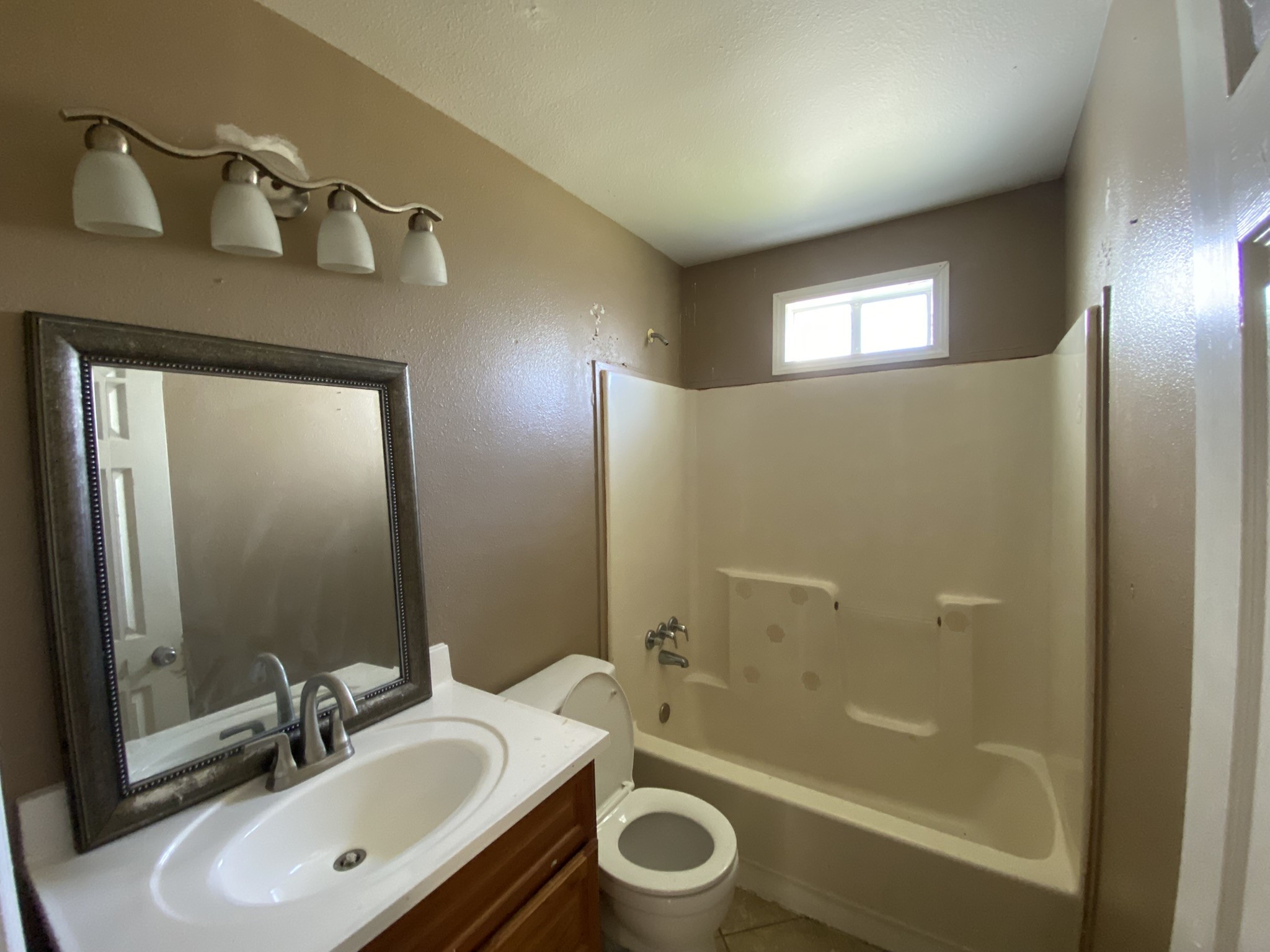 3013 Fern Street Pasadena, TX 77503 - Photo 21 of 23 a bathroom with a sink a mirror a bathtub and shower