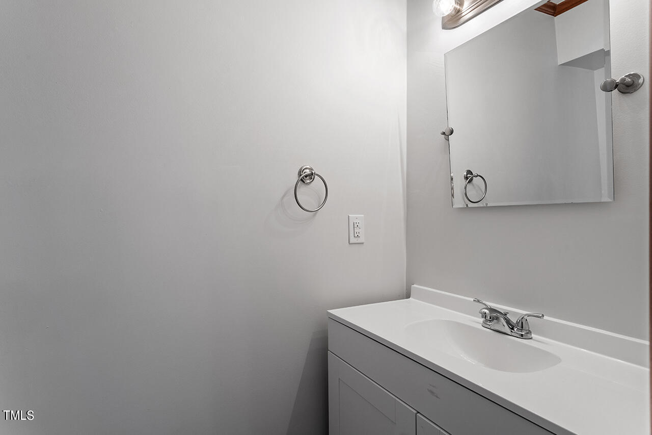 5656 Hamstead Crossing Raleigh, NC 27612 - Photo 8 of 35 a bathroom with a sink and vanity