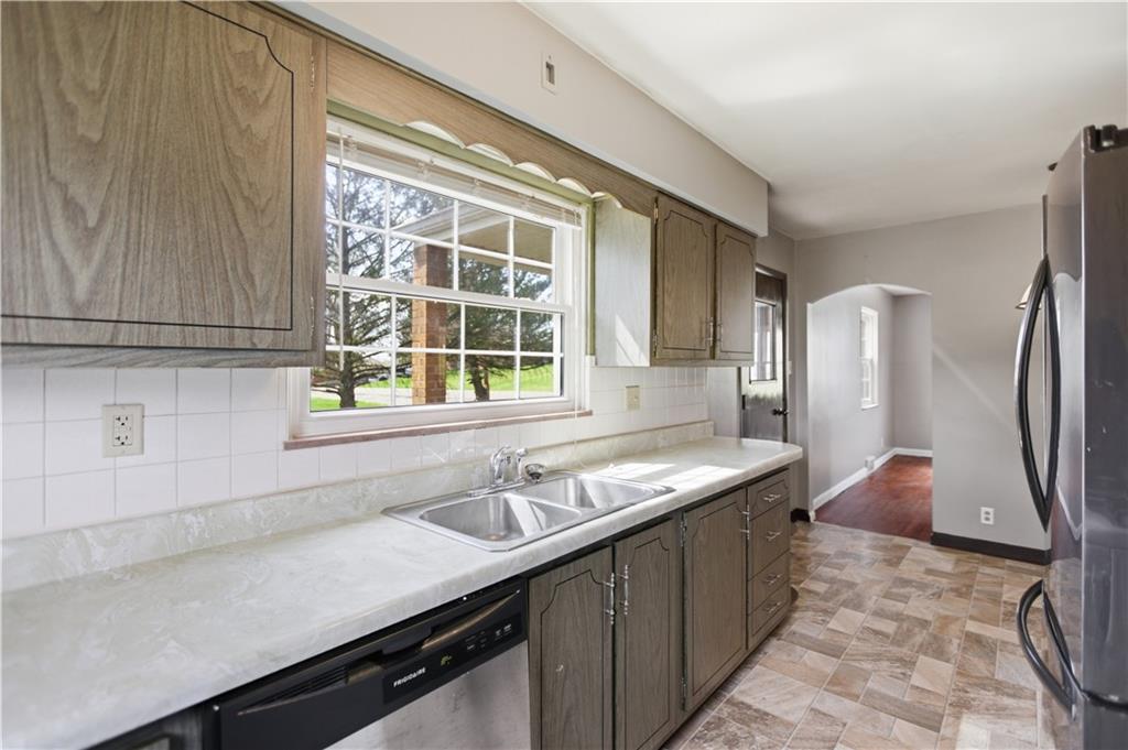 64 Harmon Creek Road Burgettstown, PA 15021 - Photo 12 of 29 a kitchen with a sink and a refrigerator