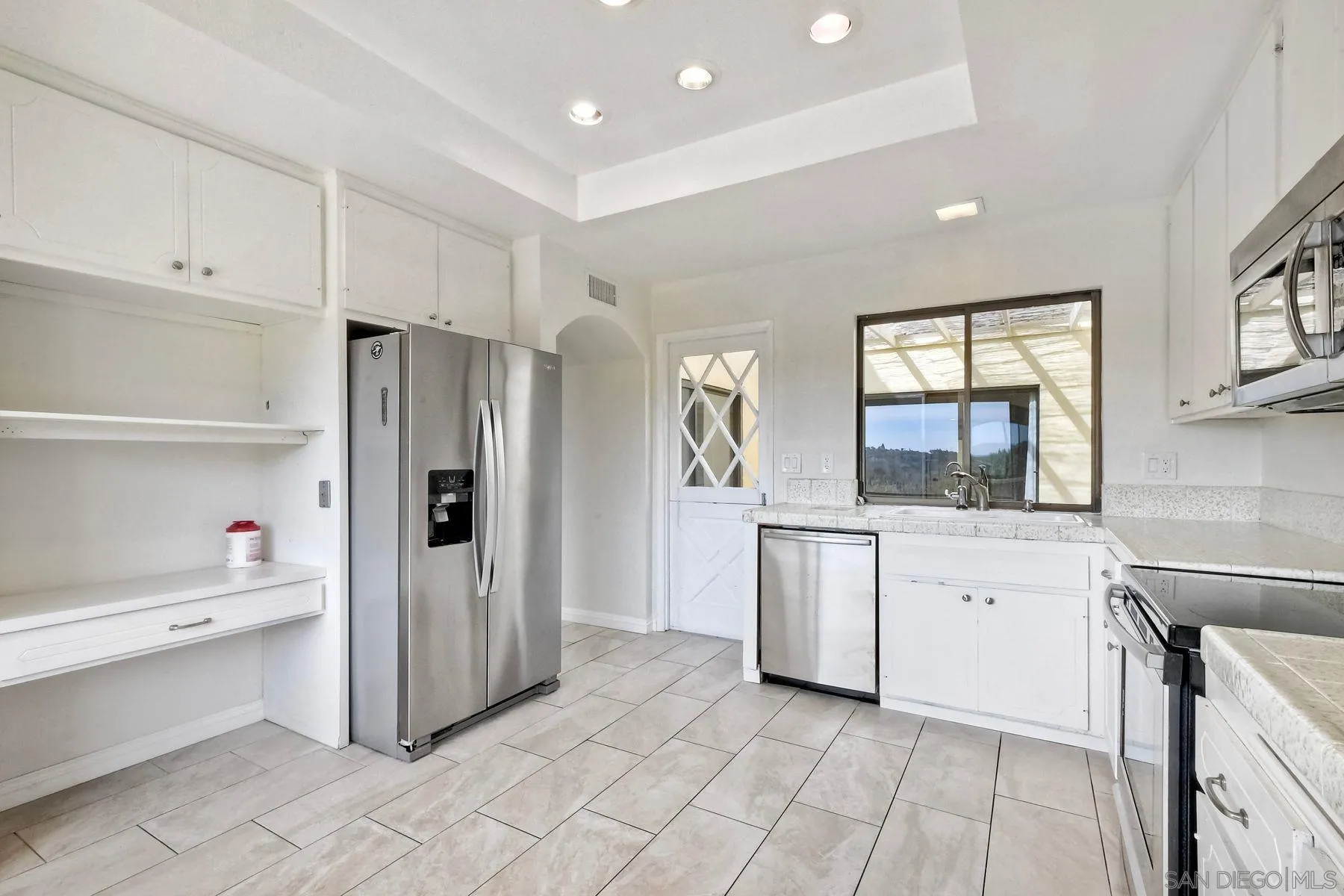 13416 The Square Poway, CA 92064 - Photo 11 of 22 a kitchen with a refrigerator and cabinets