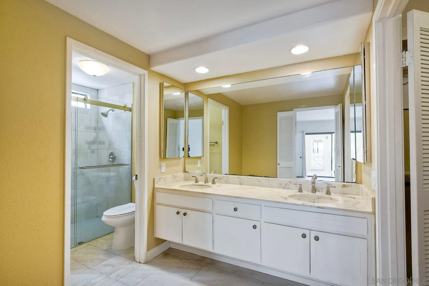 13416 The Square Poway, CA 92064 - Photo 16 of 22 a bathroom with a double vanity sink toilet mirror and bathtub