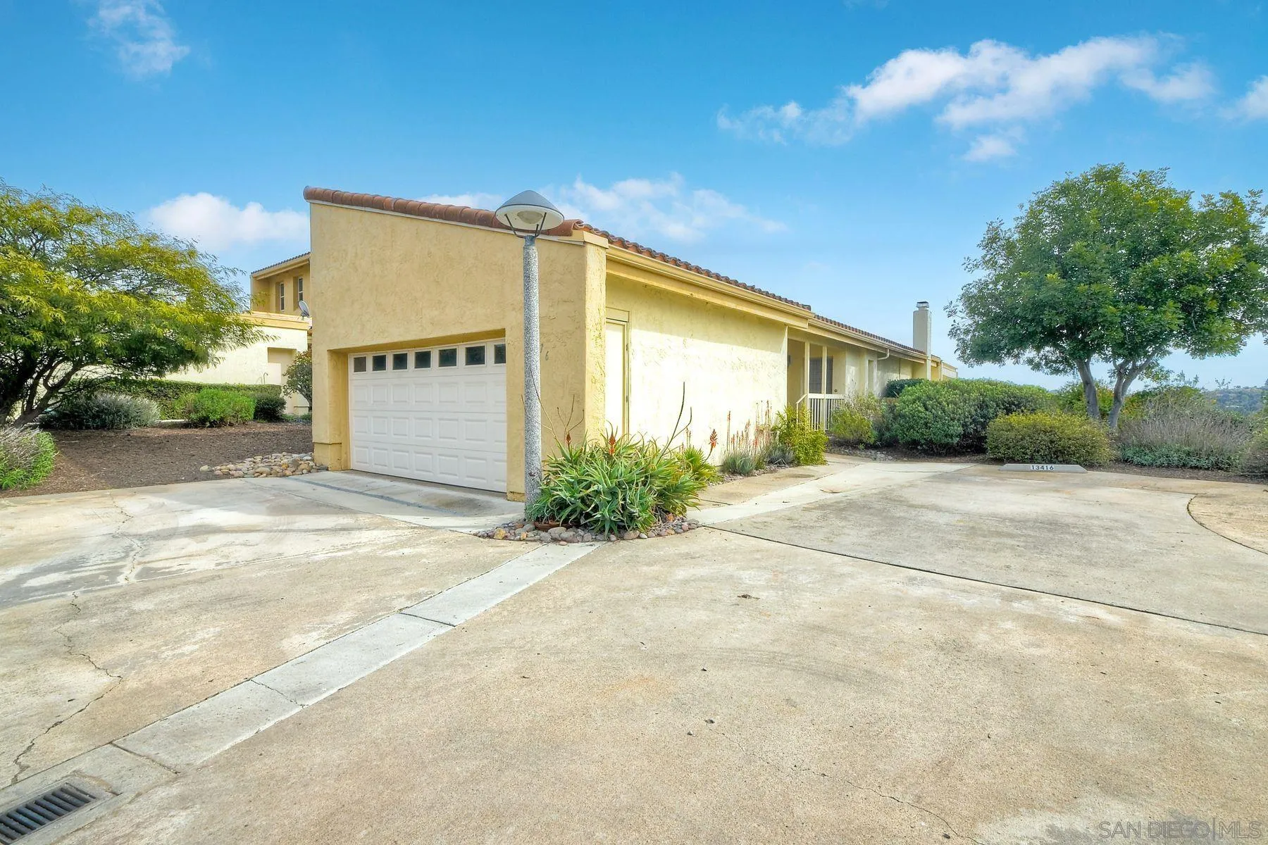 13416 The Square Poway, CA 92064 - Photo 2 of 22 a view of a house with a yard and garage