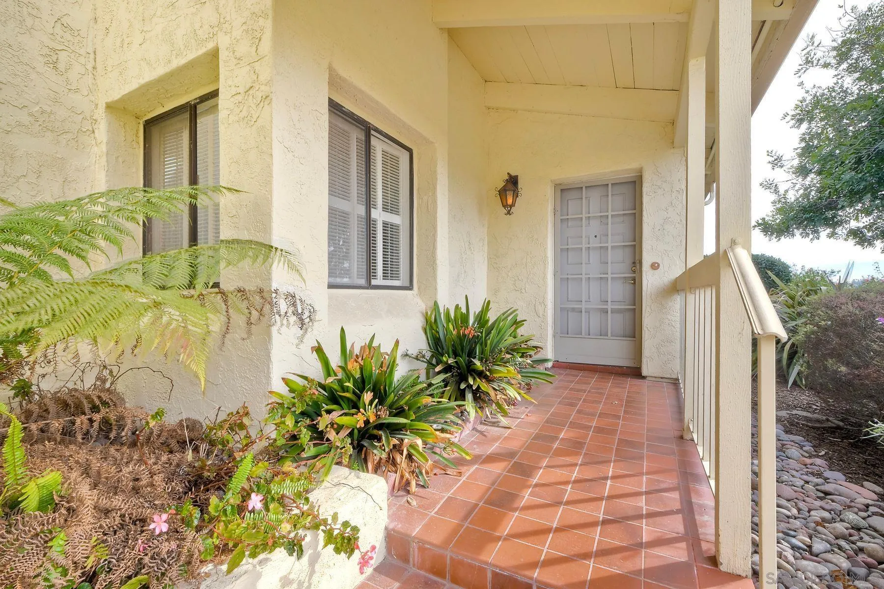 13416 The Square Poway, CA 92064 - Photo 3 of 22 a house with potted plants in front of it