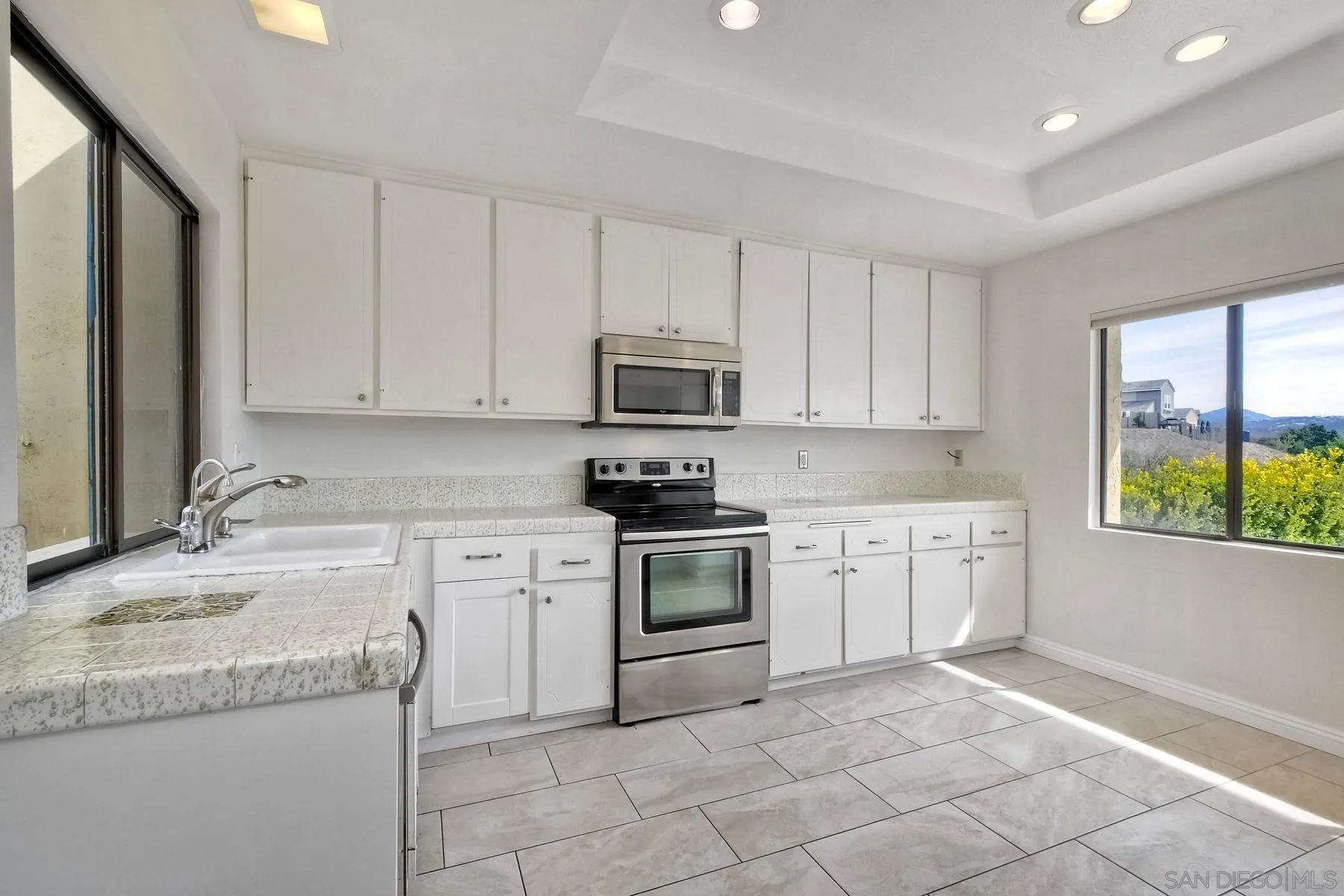13416 The Square Poway, CA 92064 - Photo 9 of 22 a kitchen with granite countertop white cabinets and stainless steel appliances