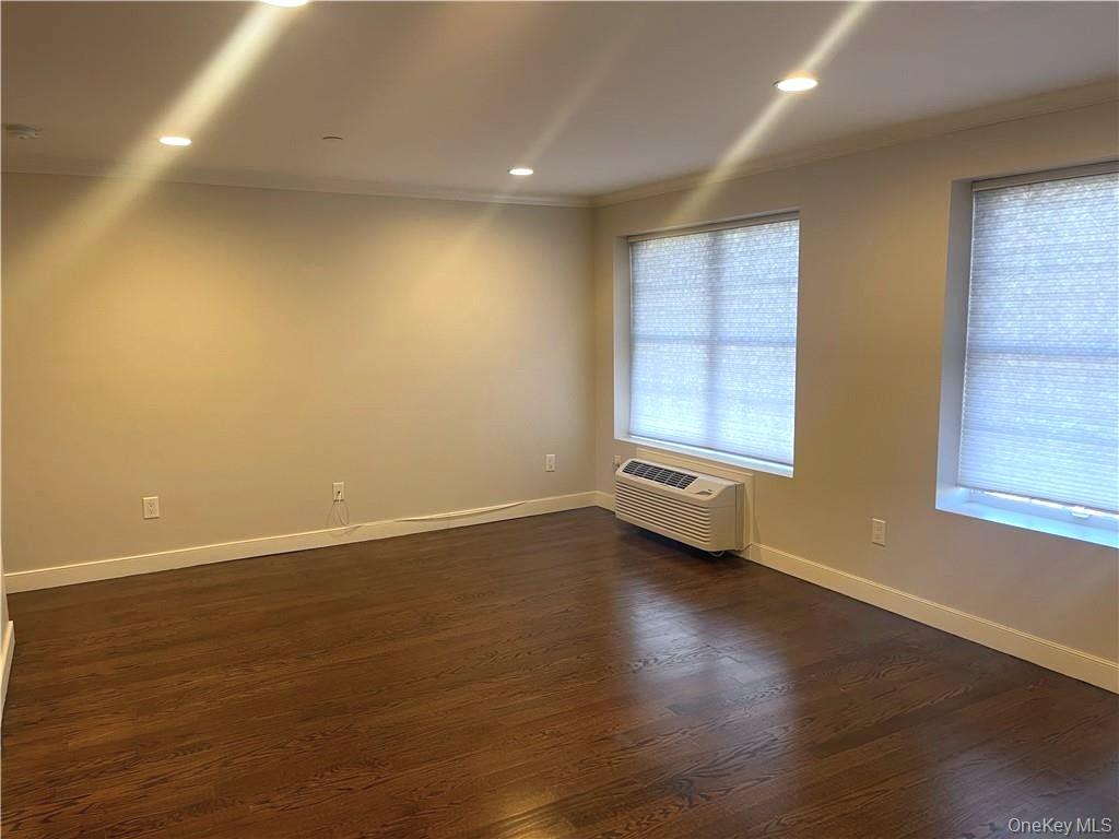 17 Cedar Street, Unit 1 Dobbs Ferry, NY 10522 - Photo 6 of 9 Unfurnished room featuring crown molding, dark wood-style flooring, recessed lighting, and a wall mounted air conditioner