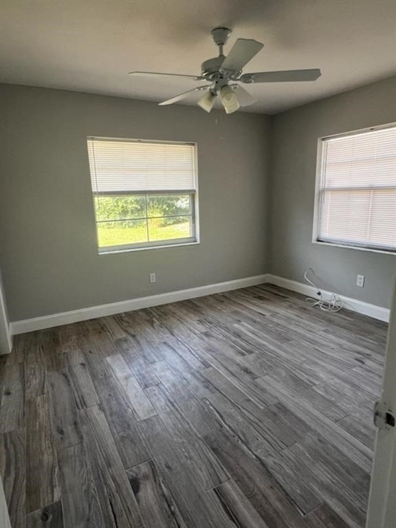 Undisclosed Address Sebastian, FL 32958 - Photo 11 of 14 wooden floor in an empty room with a window
