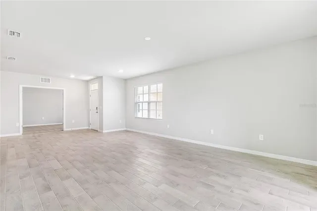 a view of an empty room with a window