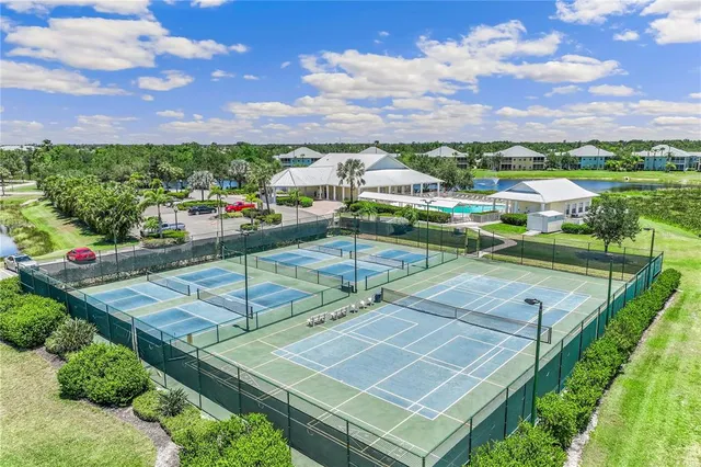 a view of a city with lots of residential buildings ocean and mountain view in back
