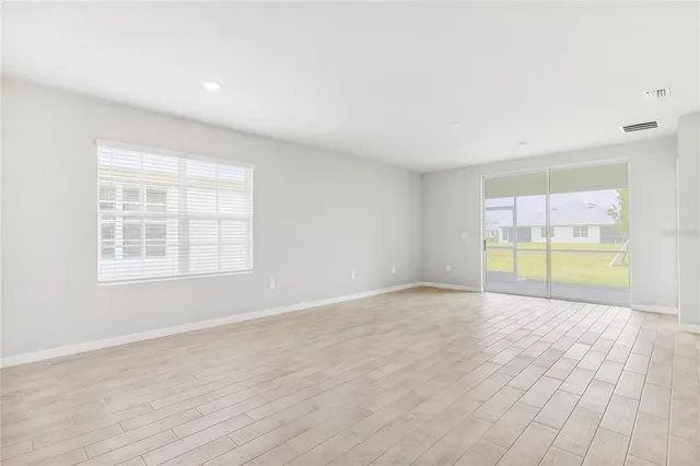 a view of large kitchen with a sink and a refrigerator