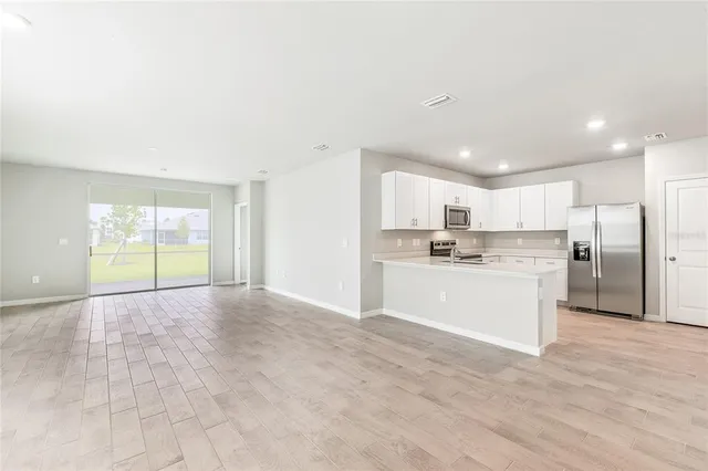 a kitchen with stainless steel appliances a refrigerator stove microwave and sink