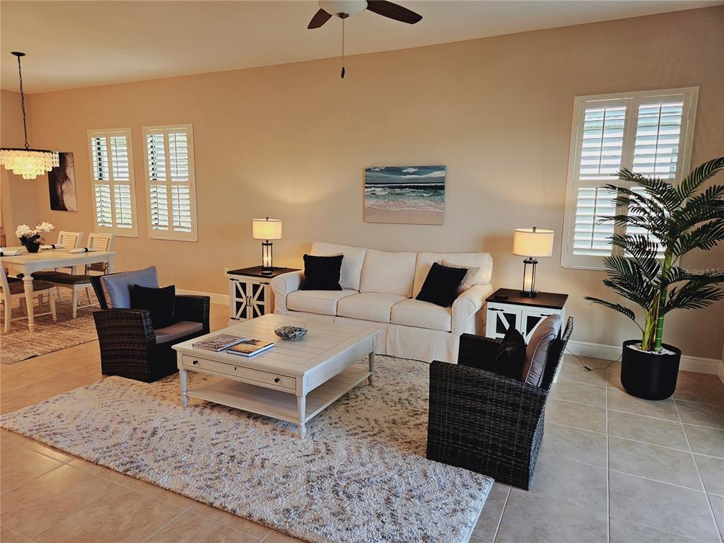 10468 Crooked Creek Drive Venice, FL 34293 - Photo 16 of 44 a living room with furniture a rug and a chandelier