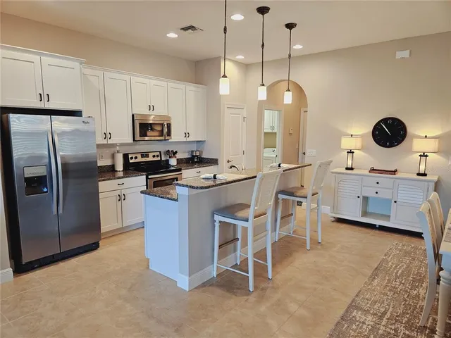 a kitchen with cabinets a sink and stainless steel appliances
