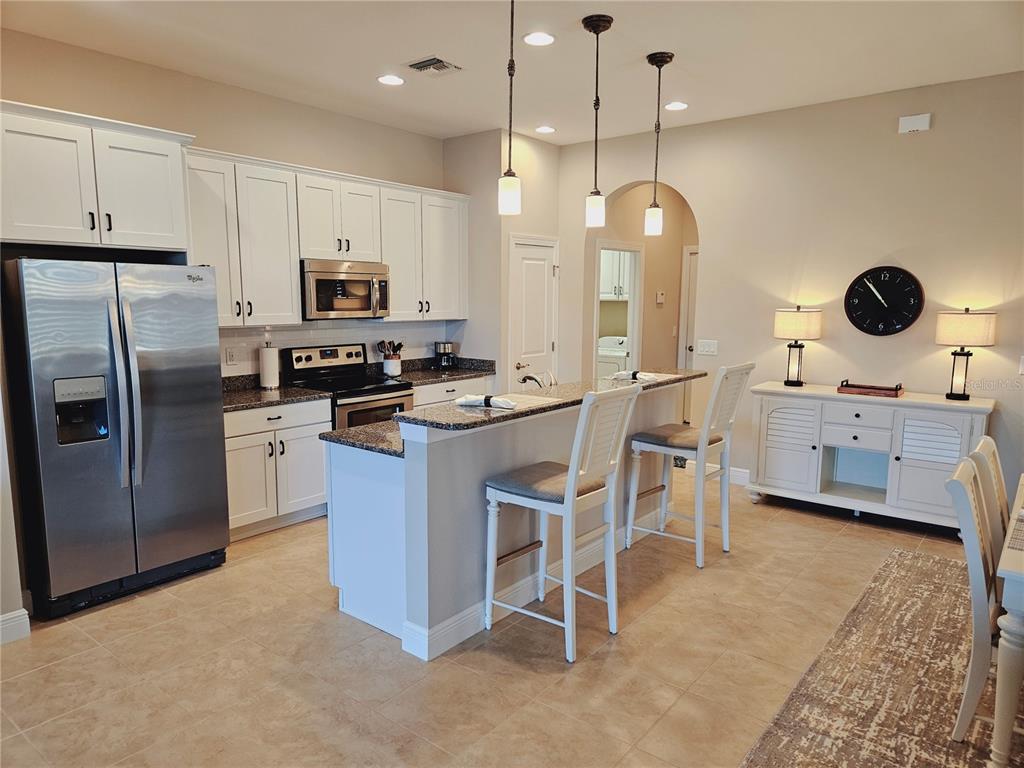 10468 Crooked Creek Drive Venice, FL 34293 - Photo 18 of 44 a kitchen with cabinets a sink and stainless steel appliances