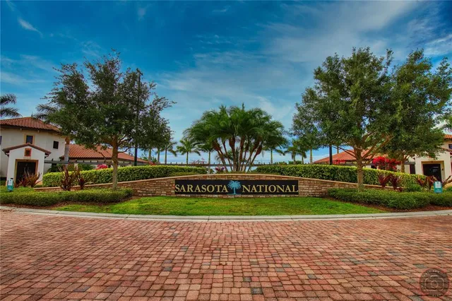 a sign board with parking space in back