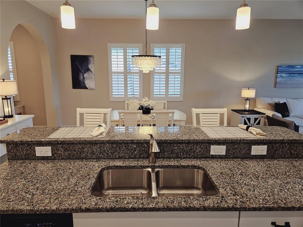 10468 Crooked Creek Drive Venice, FL 34293 - Photo 23 of 44 a kitchen with kitchen island granite countertop a sink and a granite counter tops