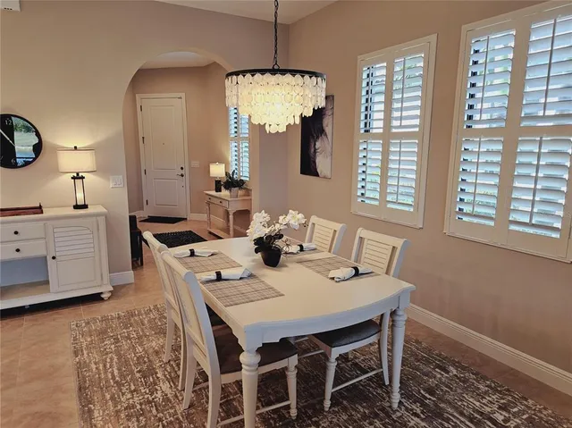 a view of a dining room with furniture and window