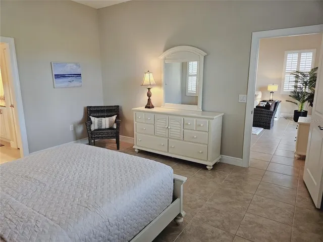 a bedroom with a bed and a chair