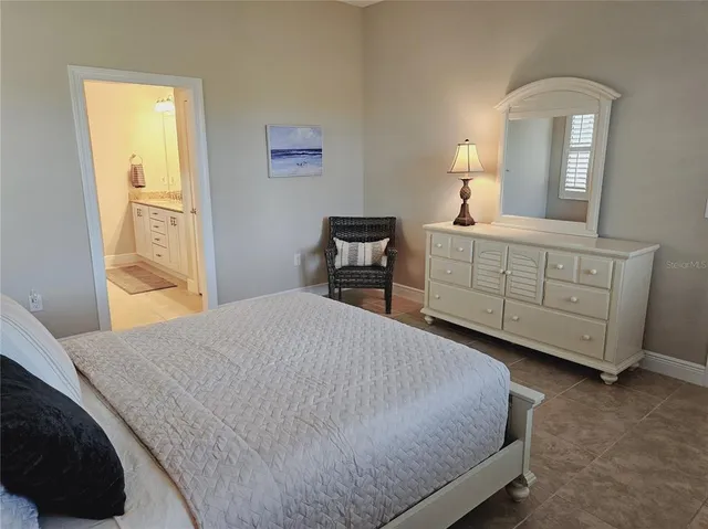 a bedroom with a bed and a dresser