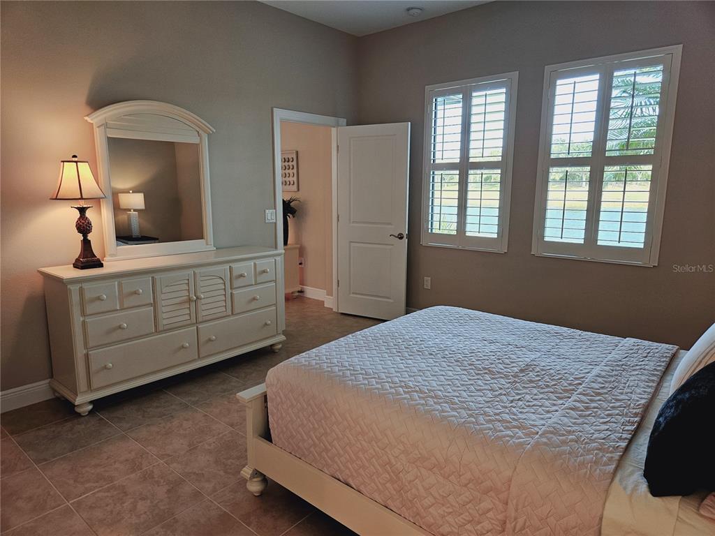 10468 Crooked Creek Drive Venice, FL 34293 - Photo 28 of 44 a bedroom with a bed and a dresser
