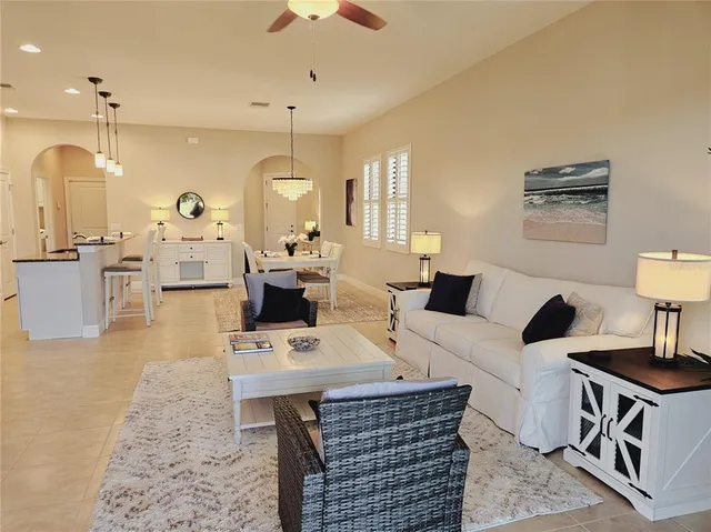 a living room with lots of furniture and a chandelier