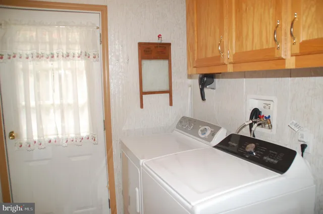 a view of a house with a yard and tree s