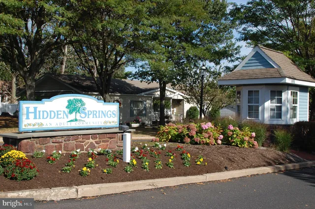 a front view of a house with a tree