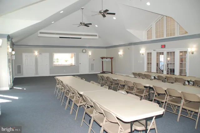 a living room with furniture and a book shelf