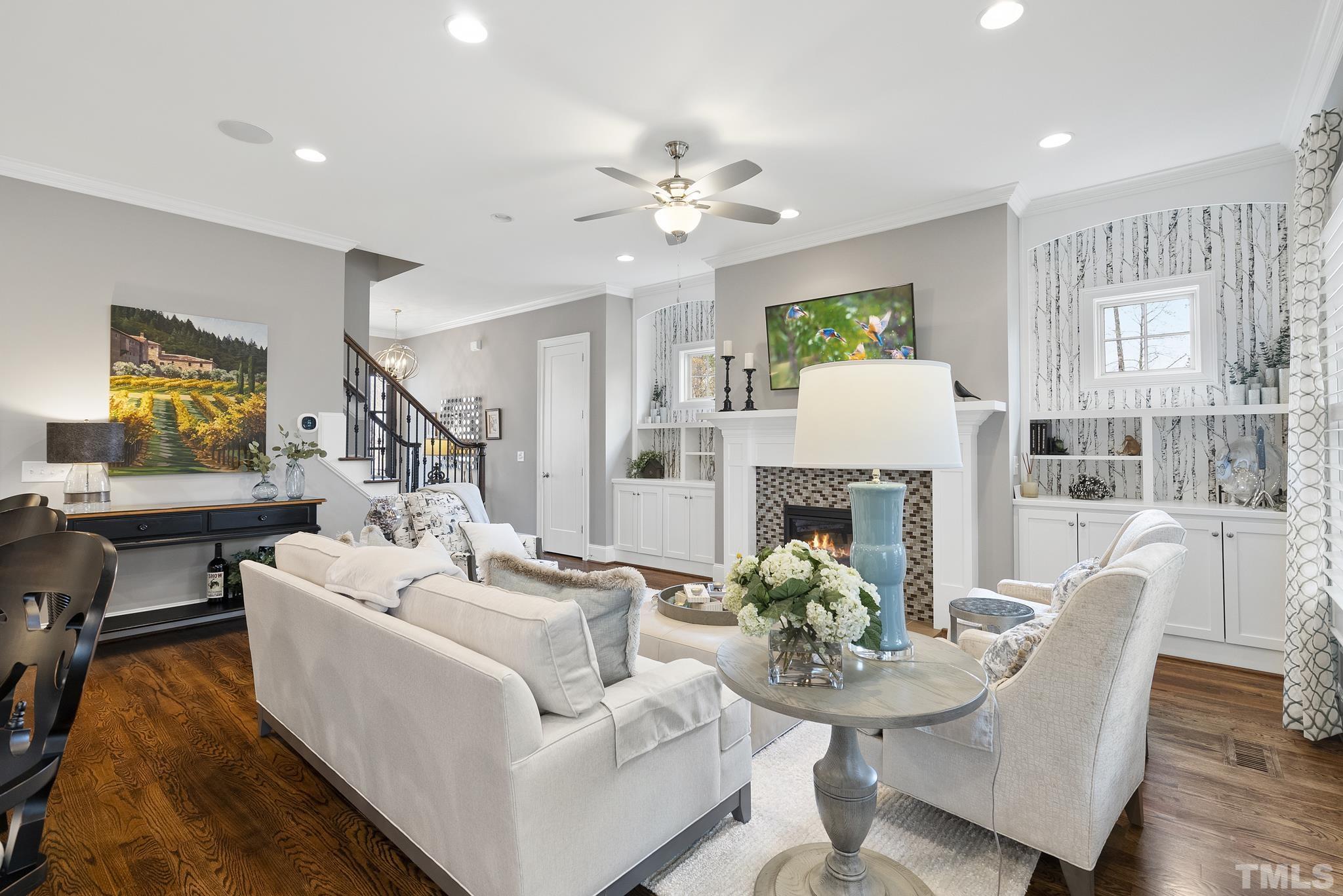 2524 Highgate Oak Drive Cary, NC 27519 - Photo 15 of 70 a living room with furniture a fireplace and a chandelier