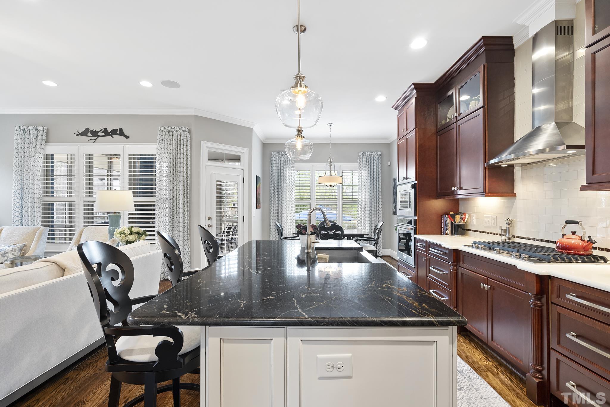 2524 Highgate Oak Drive Cary, NC 27519 - Photo 19 of 70 a kitchen with a table chairs stove and cabinets