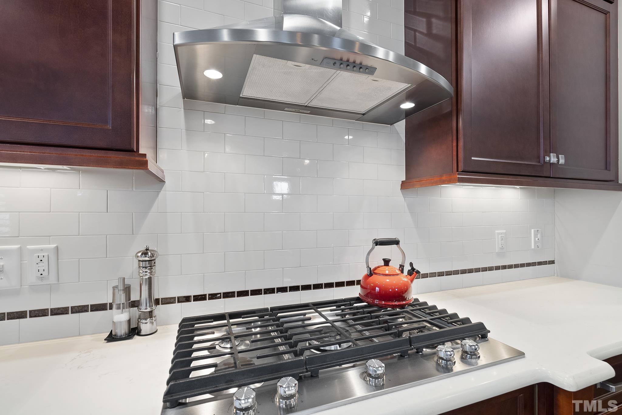 2524 Highgate Oak Drive Cary, NC 27519 - Photo 21 of 70 a kitchen with a stove and a cabinet