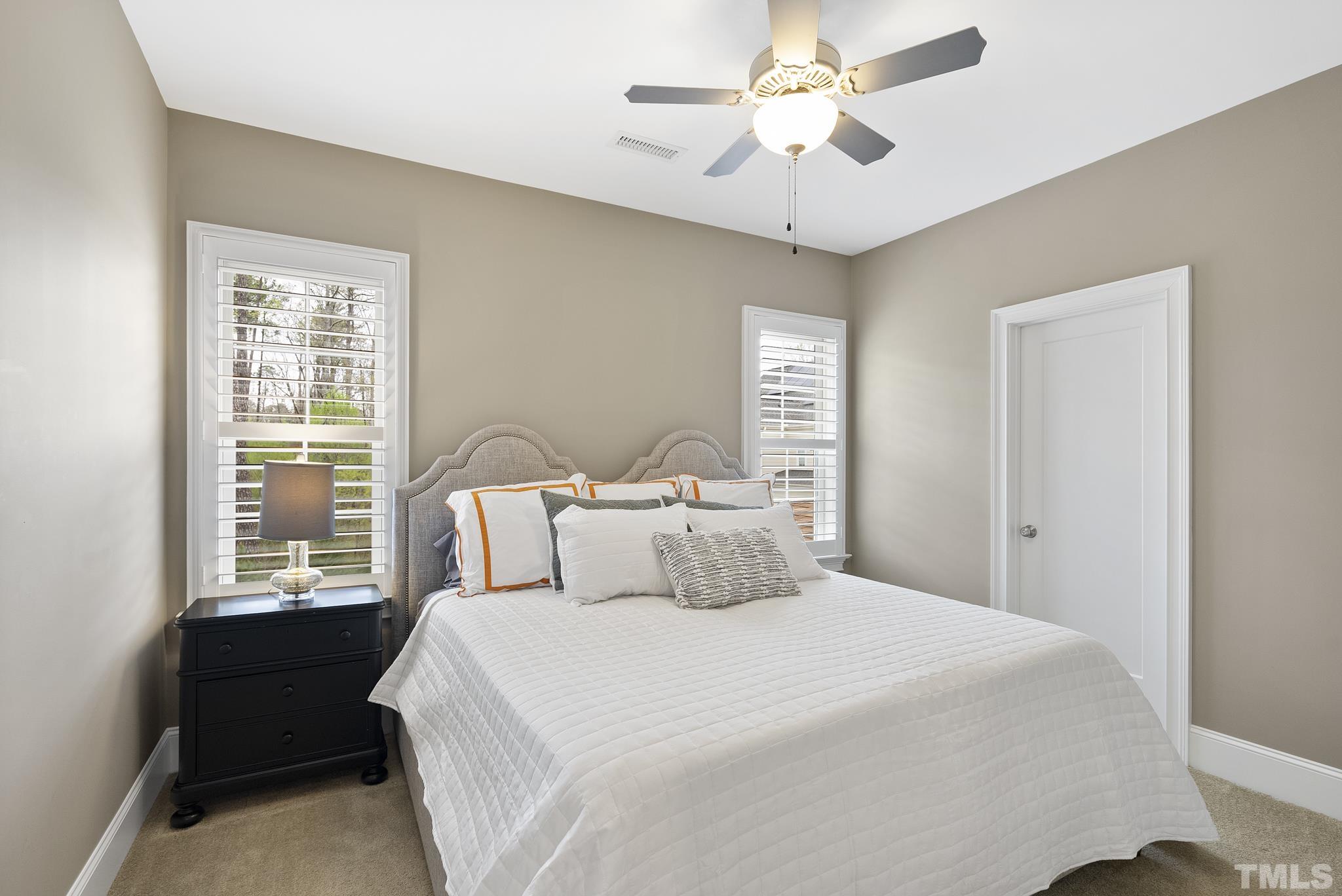 2524 Highgate Oak Drive Cary, NC 27519 - Photo 38 of 70 a bedroom with a large bed and a chandelier