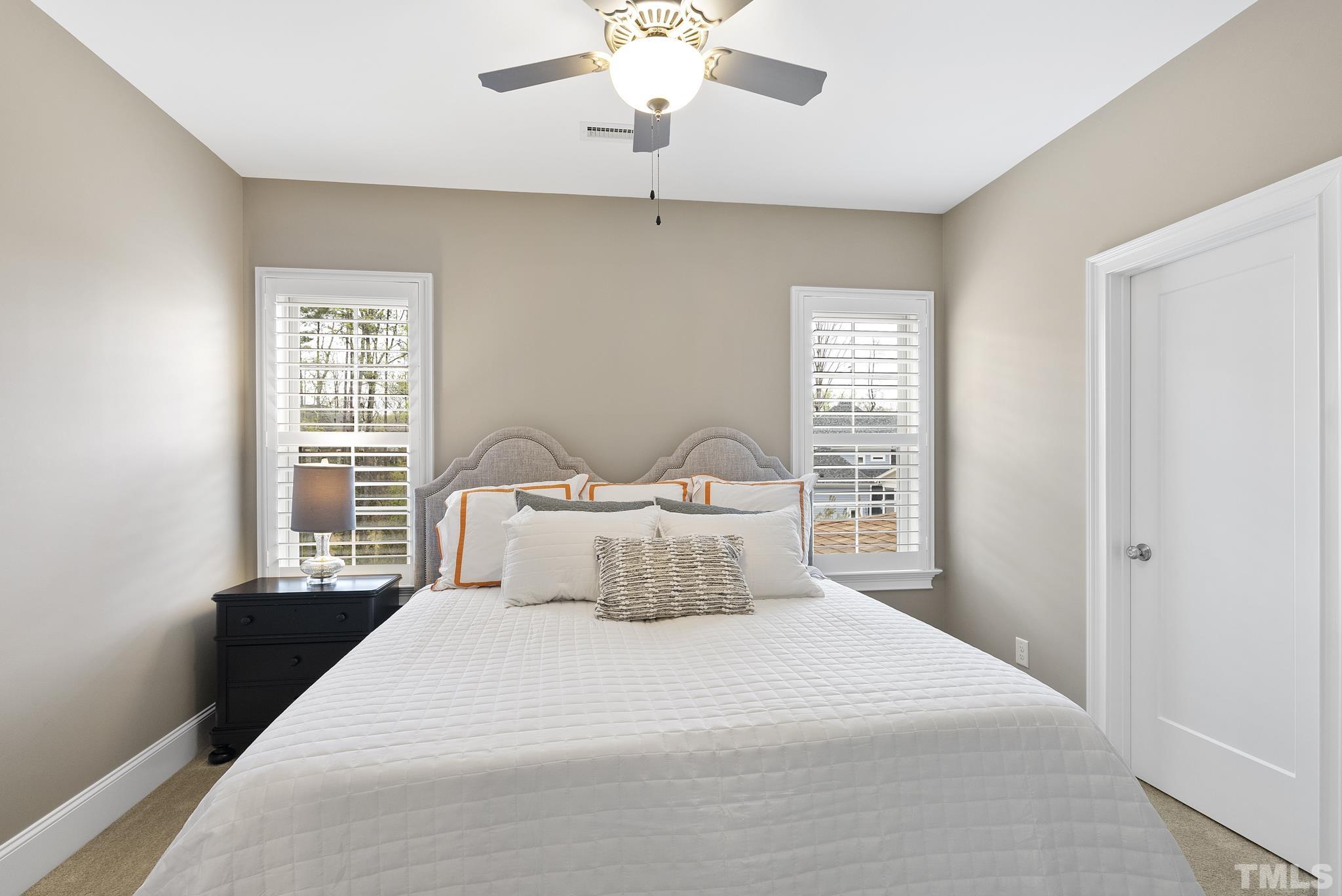 2524 Highgate Oak Drive Cary, NC 27519 - Photo 39 of 70 a bedroom with a large bed and a chandelier