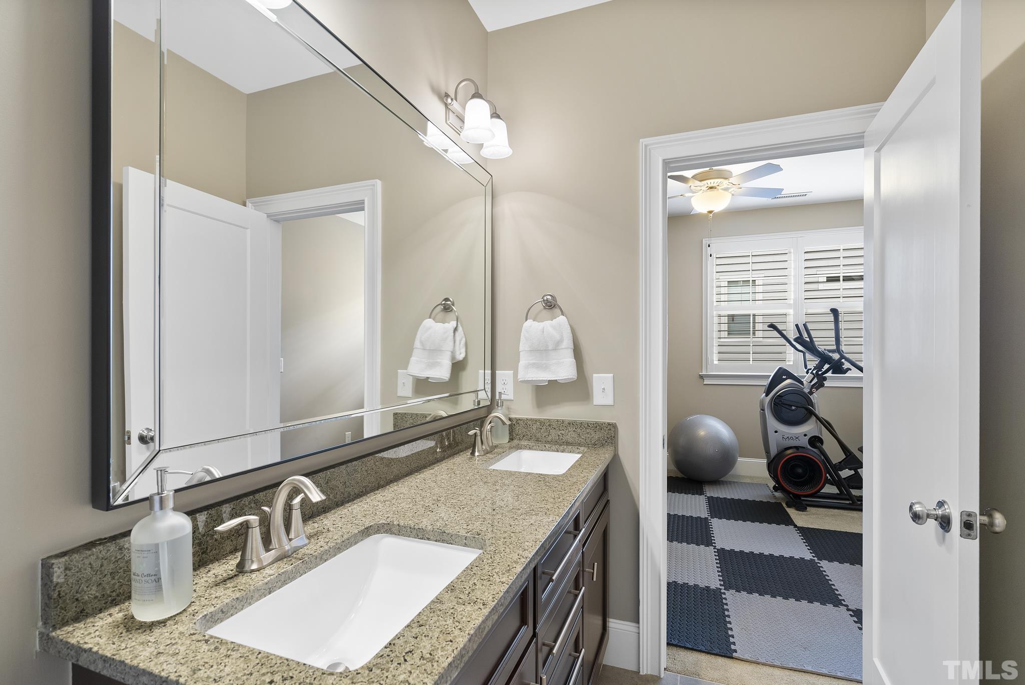 2524 Highgate Oak Drive Cary, NC 27519 - Photo 40 of 70 a bathroom with a granite countertop sink a mirror and shower