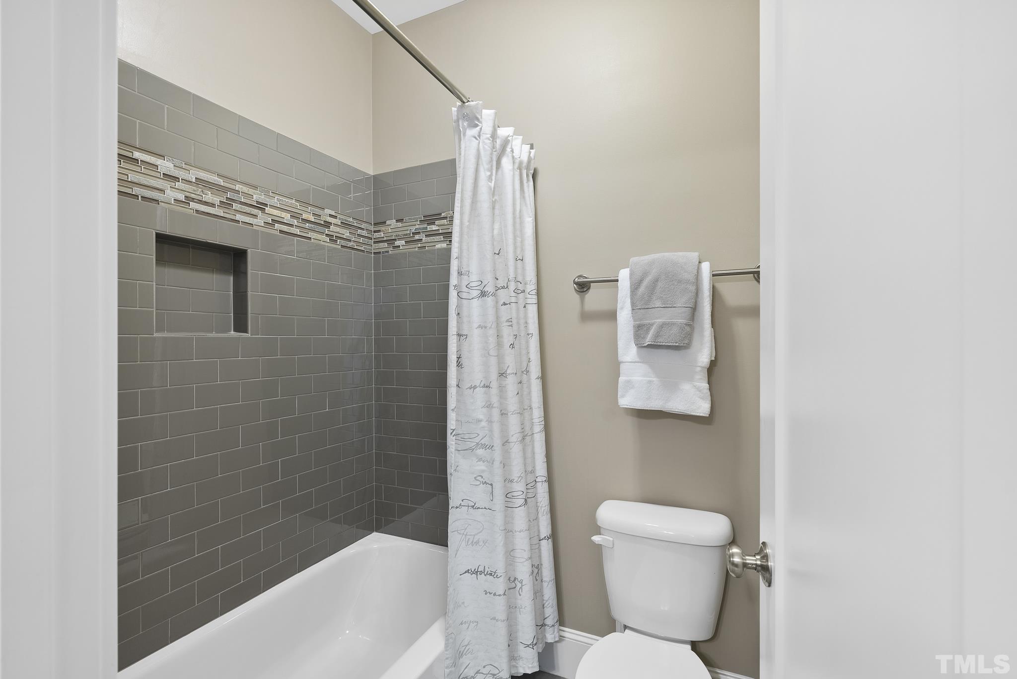 2524 Highgate Oak Drive Cary, NC 27519 - Photo 41 of 70 a bathroom with a shower a toilet and sink