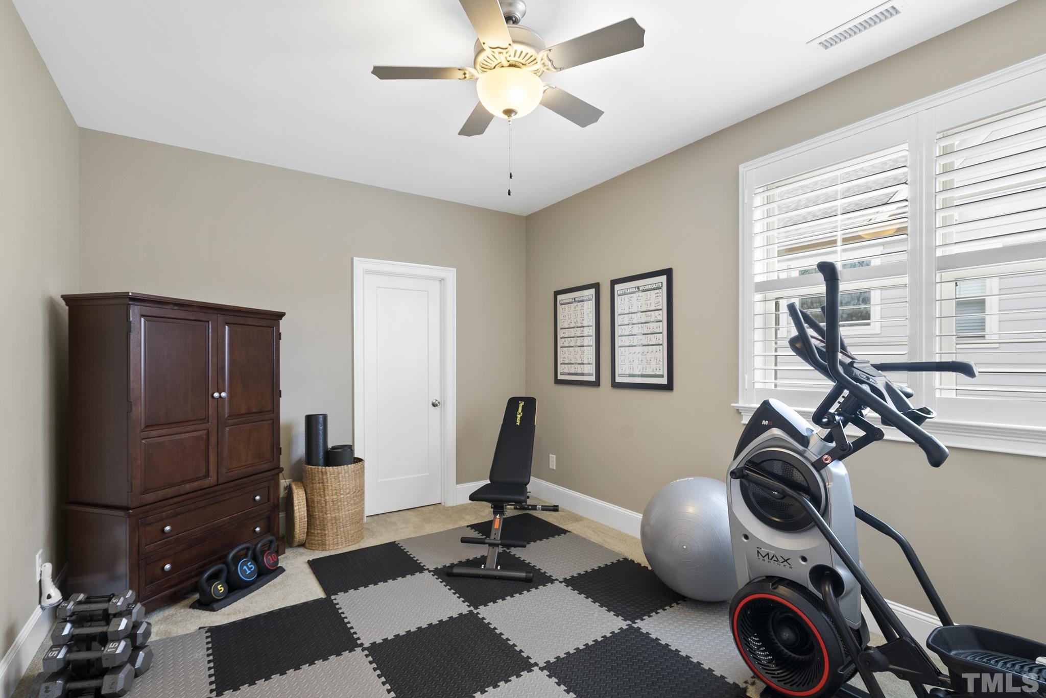 2524 Highgate Oak Drive Cary, NC 27519 - Photo 43 of 70 a room with gym equipment and windows