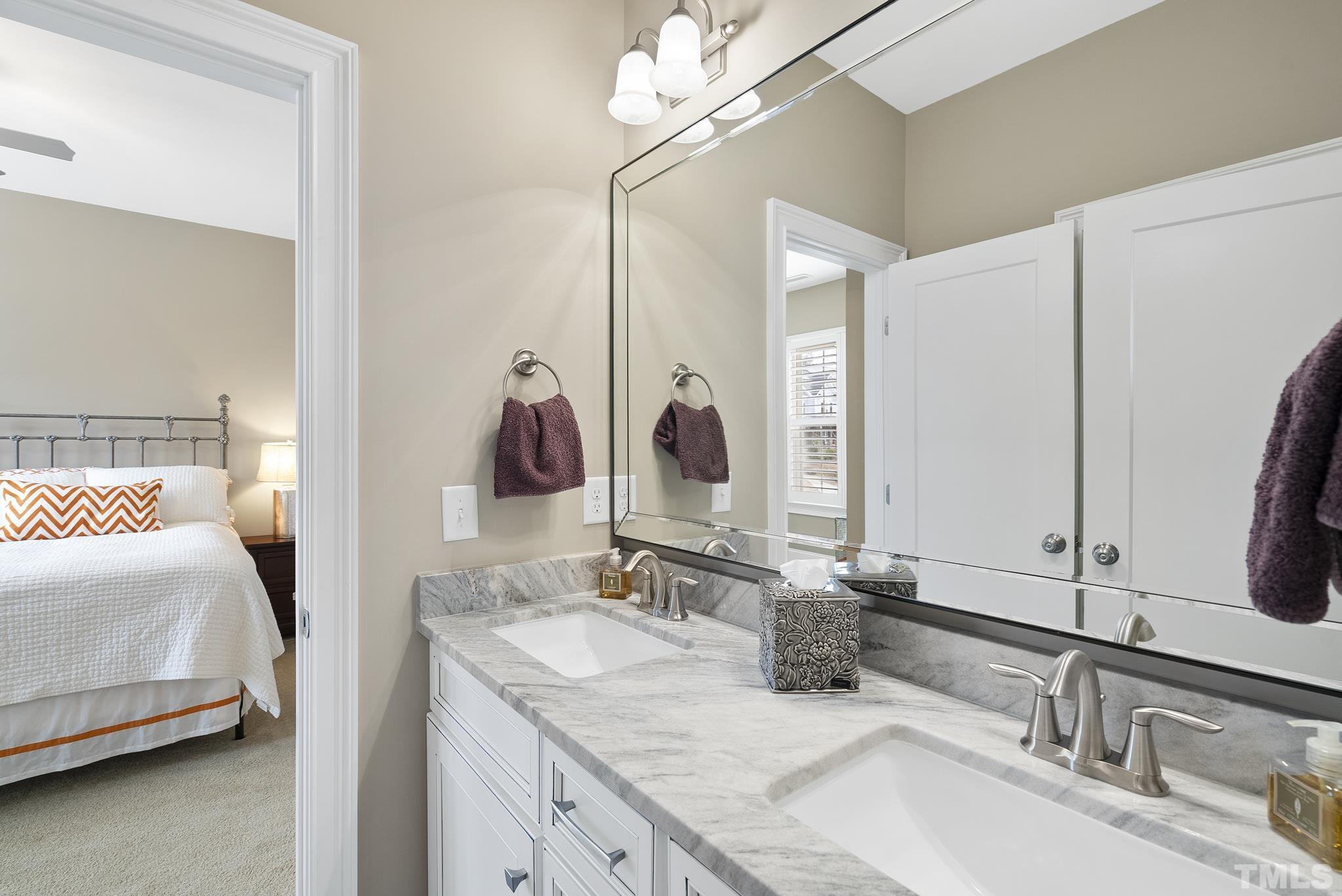 2524 Highgate Oak Drive Cary, NC 27519 - Photo 46 of 70 a en suite bathroom with a double vanity sink and a mirror