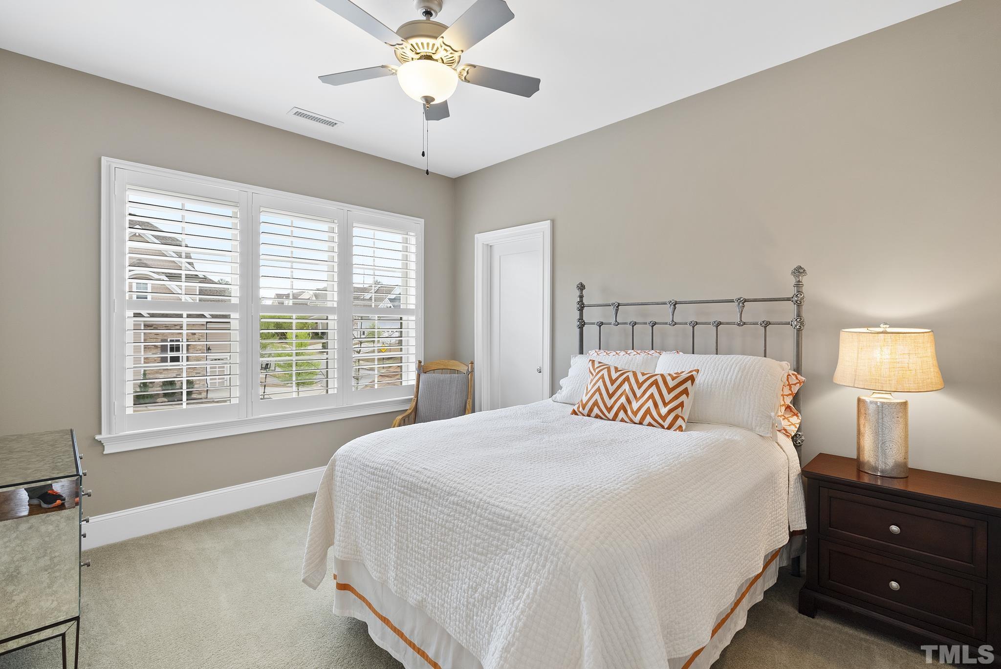 2524 Highgate Oak Drive Cary, NC 27519 - Photo 47 of 70 a bedroom with a bed and a lamp