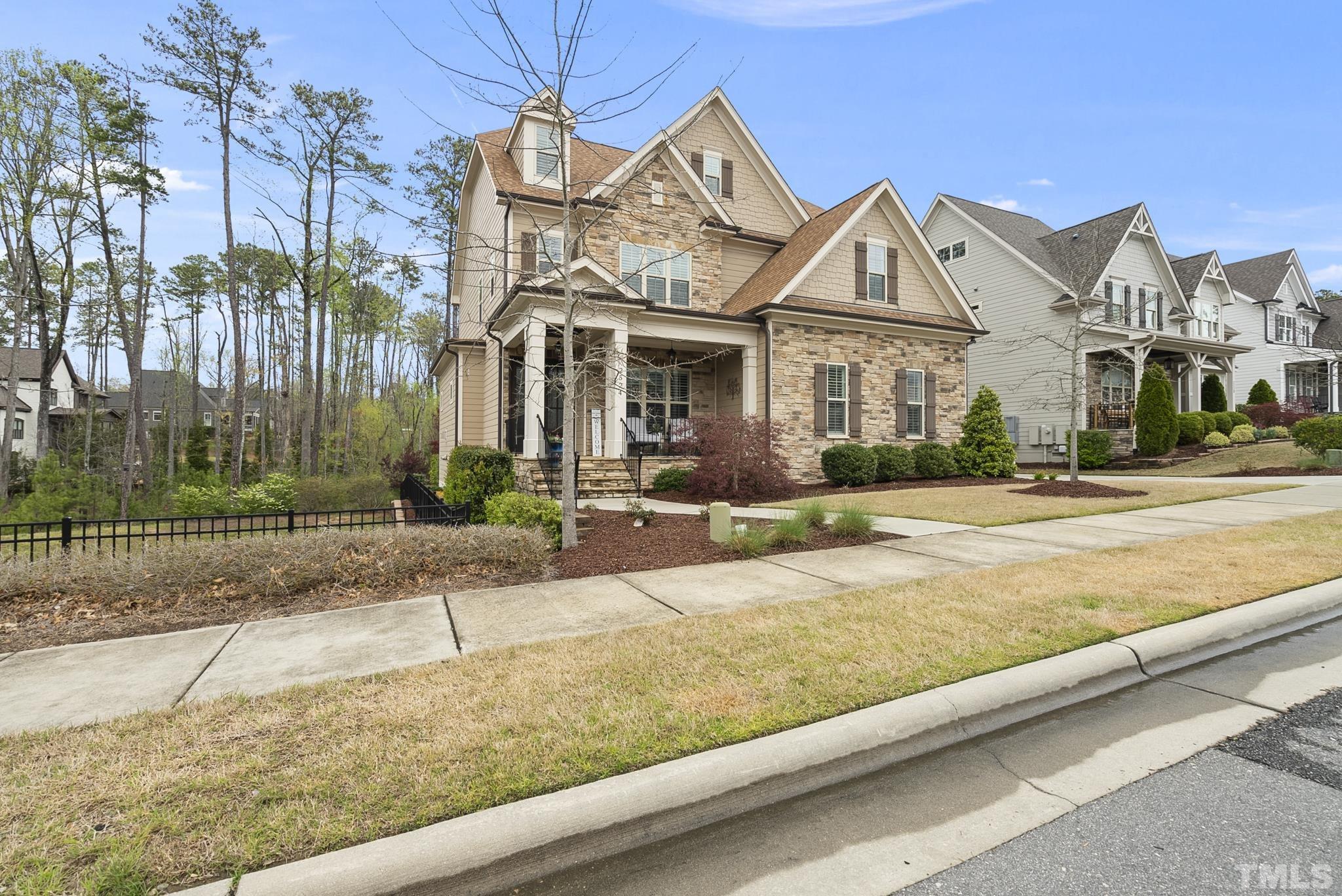 2524 Highgate Oak Drive Cary, NC 27519 - Photo 69 of 70 a front view of a house with a garden and plants