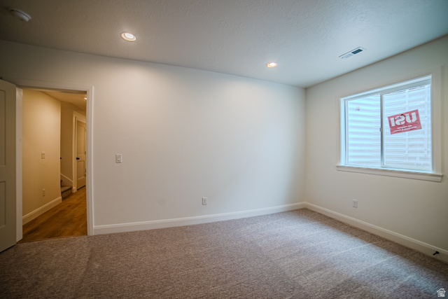 223 South Cottonwood Road, Unit 7501 Vineyard, UT 84059 - Photo 5 of 45 Spacious room featuring neutral carpeting, recessed lighting, white walls, and a window with white trim