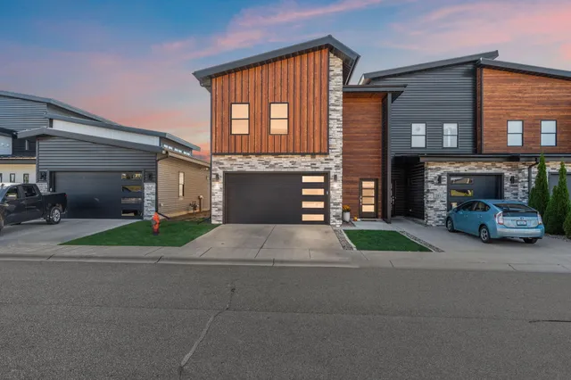 a front view of a house with a yard and a garage
