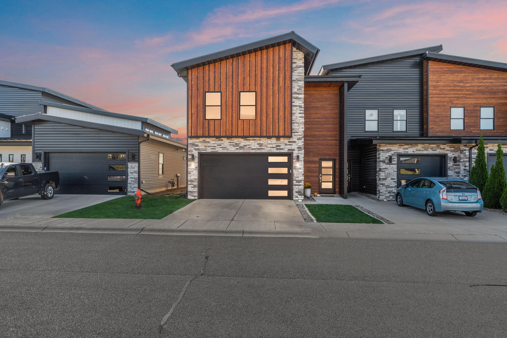 a front view of a house with a yard and a garage