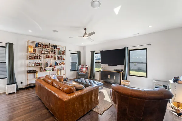 a living room with furniture a flat screen tv and a fireplace
