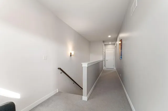 a spacious bedroom with a bed and a table in it